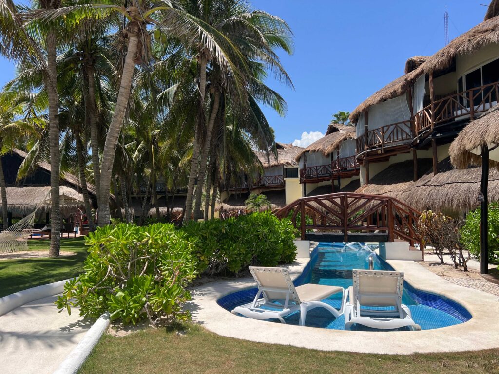 Resort pool and tropical landscaping at El Dorado Casitas Royale