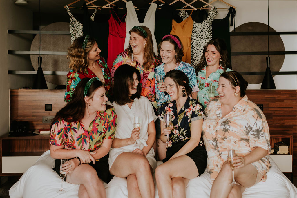 Bride and bridesmaids smiling getting ready together before a destination wedding at Majestic Elegance Costa Mujeres.