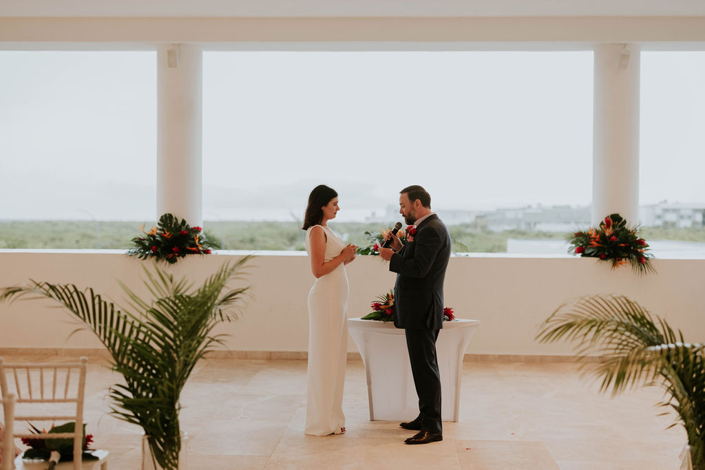 Bride and groom exchanging vows during their intimate destination wedding ceremony in Costa Mujeres, Mexico.