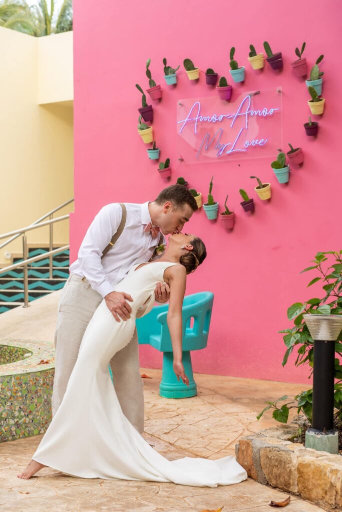 Newlyweds posing for colorful wedding photos at El Dorado Casitas Royale in Riviera Maya