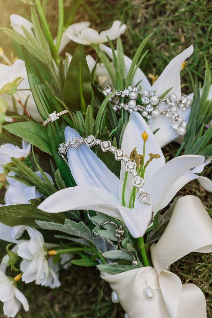 Bride's wedding bouquet with engagement ring and jewelry details at El Dorado Royale Mexico wedding