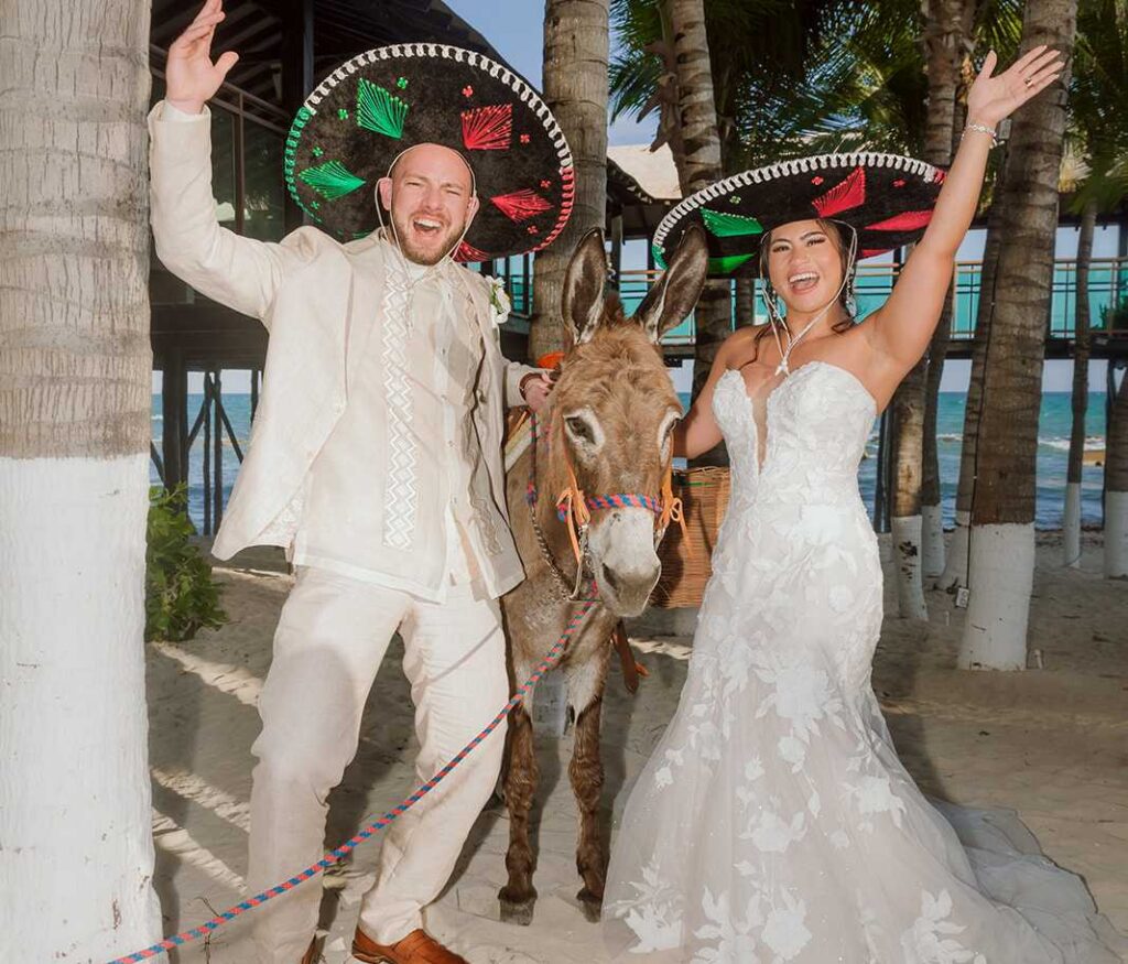 Bride and groom with Lupito donkey during cocktail hour at El Dorado Royale wedding