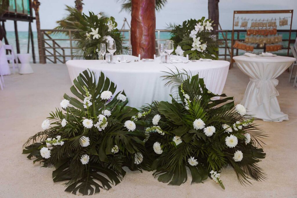 Reception decor and sweetheart table at Palapa Ganesha overlooking the Caribbean Sea