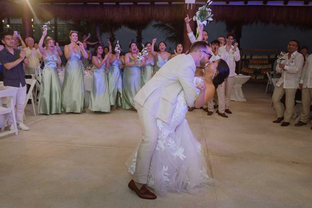 Bride and groom celebrating during reception at Palapa Ganesha in Riviera Maya