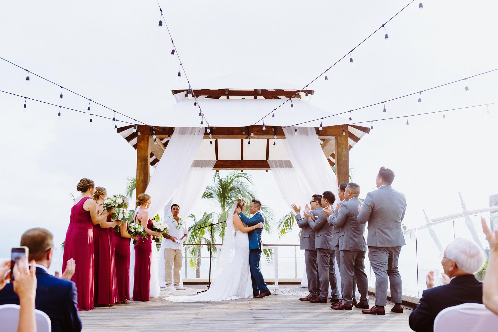 Couple at their beach wedding ceremony, showing why it matters to ​have a wedding planner for destination wedding