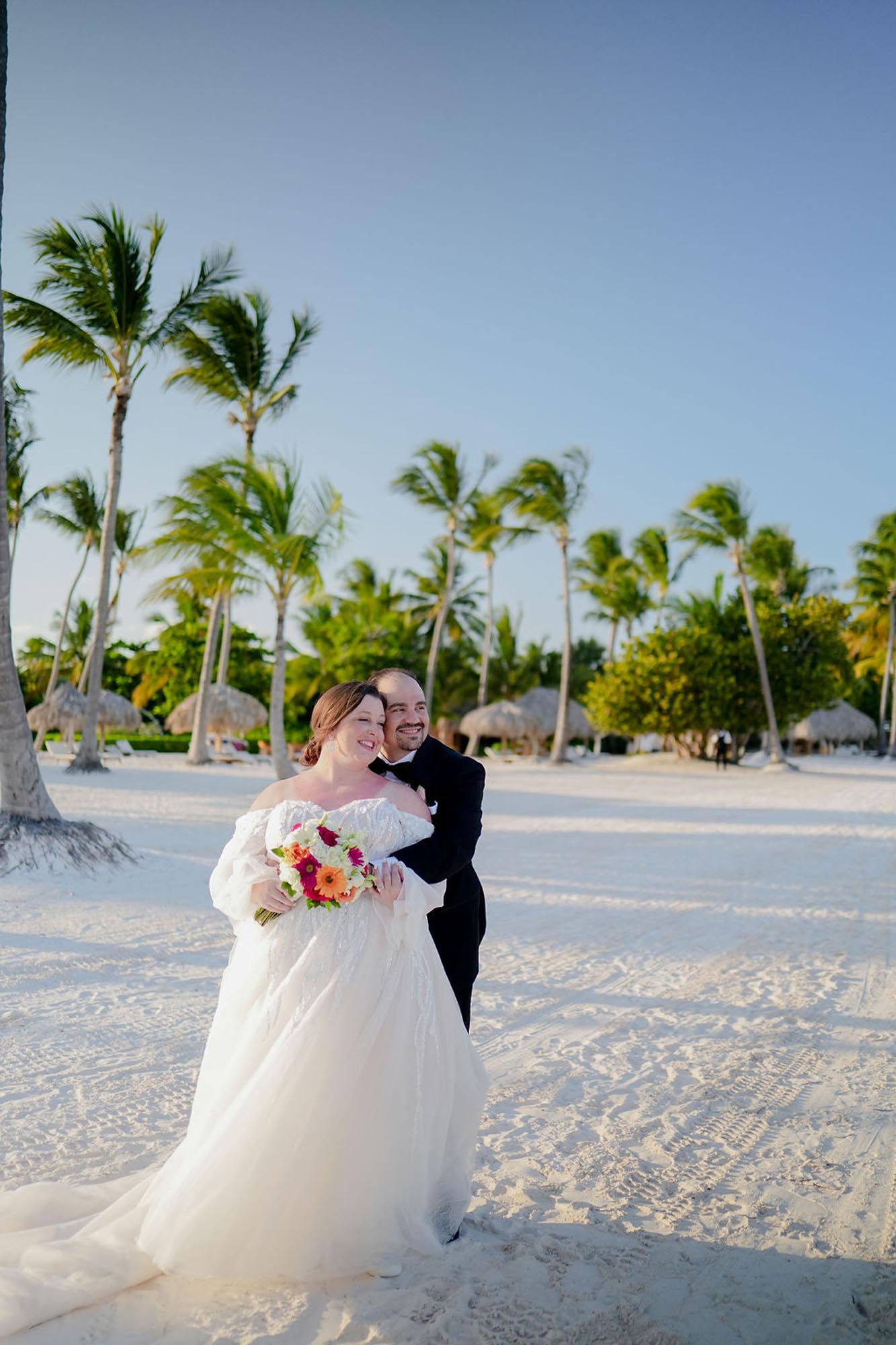 Couple embracing on a beach in Mexico after deciding to show destination wedding planner vs destination wedding travel agent.