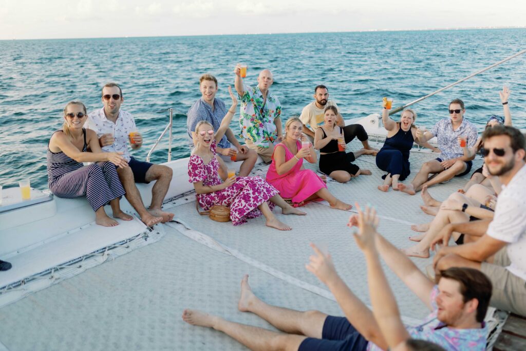 Guests enjoying a catamaran excursion to Isla Mujeres during a mexico destination wedding celebration in riviera maya planned by making memories by morgan