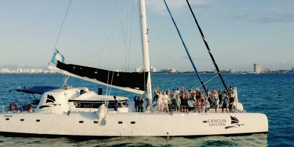 Group sunset catamaran excursion in Cancun during wedding couples Mexico destination wedding festivities