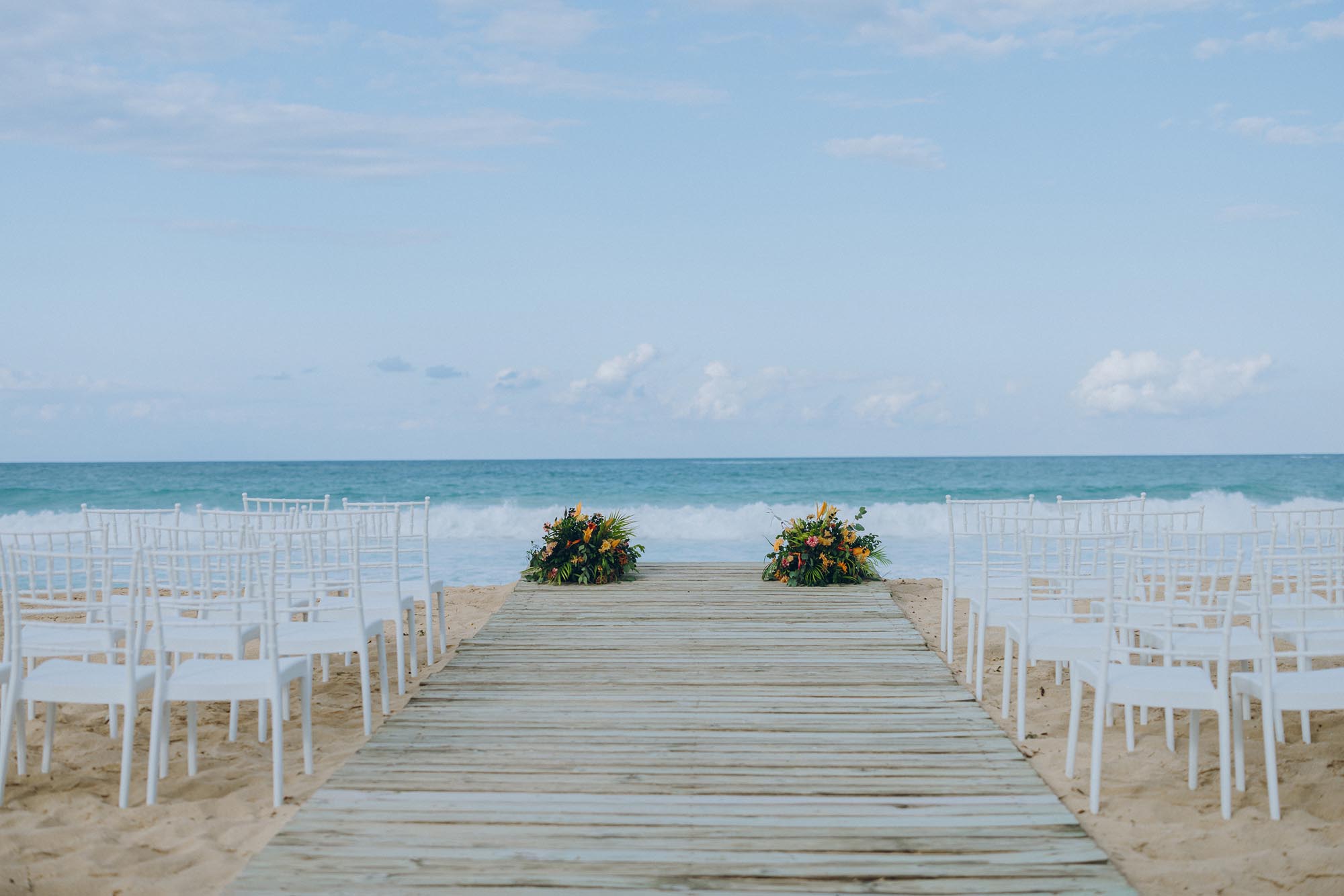 Ceremony site set up on the beach showing why it matters to ​have a wedding planner for destination wedding