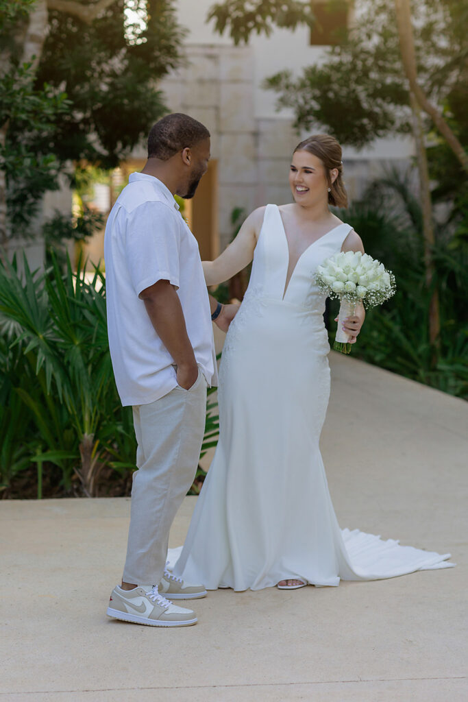 Bride and groom laughing together during a private first look at their Riviera Maya destination wedding
