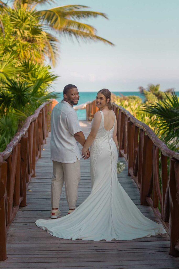 Bride and groom sharing a quiet moment on a tropical bridge at Unico 2087