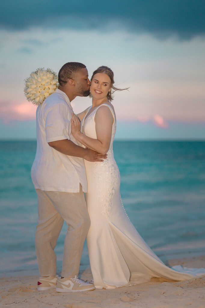 Romantic beach portrait of newlyweds at sunset during their Riviera Maya destination wedding
