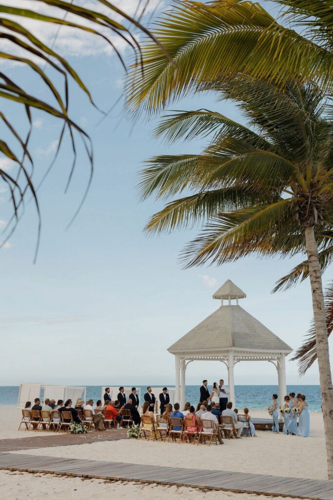 Beach wedding ceremony under a white gazebo at a destination wedding venue in Mexico