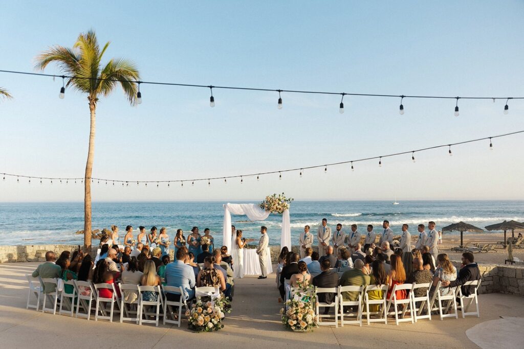 Oceanfront destination wedding ceremony at sunset in Los Cabos, Mexico