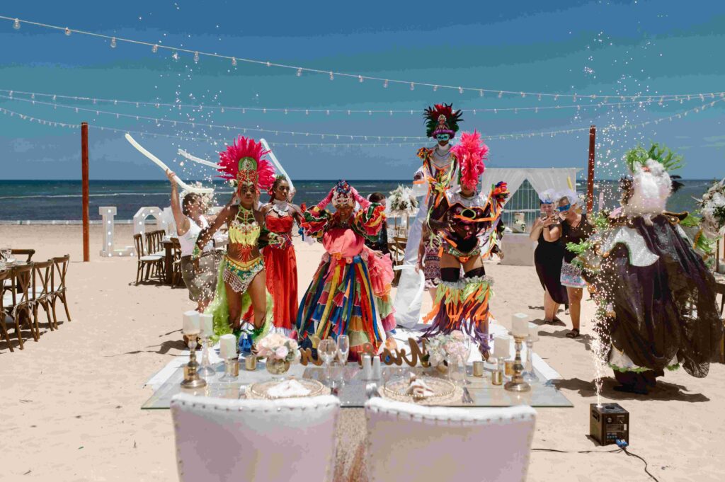 Costumed carnival entertainers for hora loca with sparklers performing at a destination wedding reception