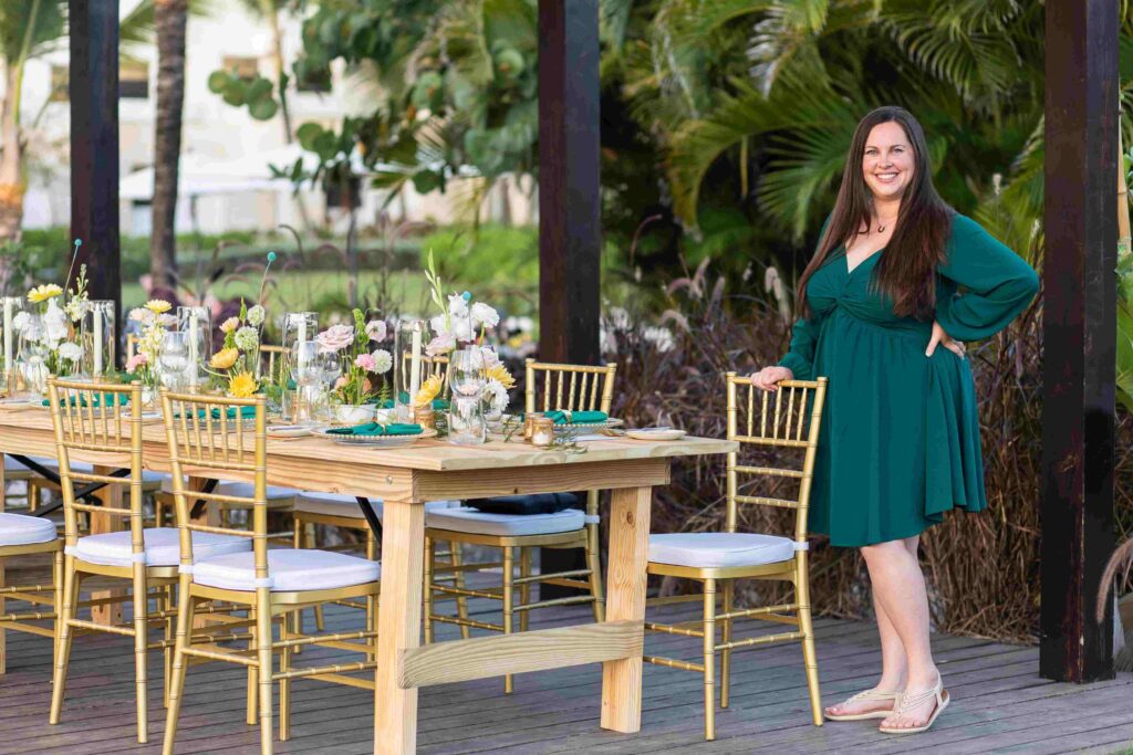 Morgan, destination wedding travel agent and wedding planner, standing at a reception table at a Dominican Republic venue